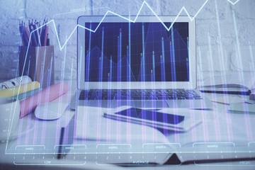 Stock market graph and table with computer background. Double exposure. Concept of financial analysis.