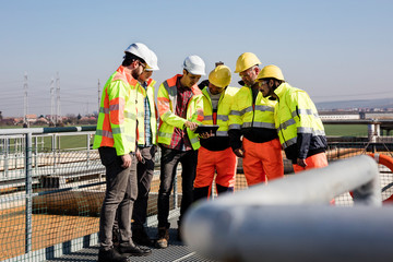 Engineers and workers assesing wastewater plant
