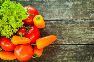 Fresh rustic vegetables on a wooden table.