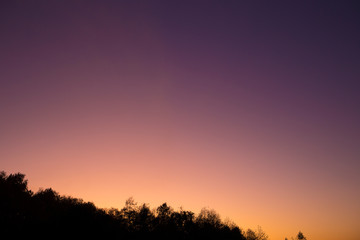 Obraz na płótnie Canvas Autumn sunset sky at blue hour