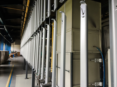 Industrial conveyor line at the factory for metal parts. Pretreatment of the surface of parts and paint parts with powder paint.