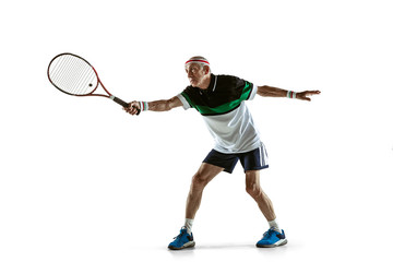 Fototapeta na wymiar Senior man wearing sportwear playing tennis isolated on white background. Caucasian male model in great shape stays active and sportive. Concept of sport, activity, movement, wellbeing. Copyspace, ad.