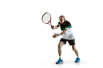 Fototapeta na wymiar Senior man wearing sportwear playing tennis isolated on white background. Caucasian male model in great shape stays active and sportive. Concept of sport, activity, movement, wellbeing. Copyspace, ad.