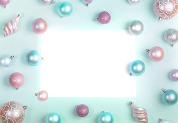 Christmas festive mockup flat lay of Christmas balls around blank white sheet on trendy Neo Mint background. 