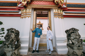 Male tourists in a Buddhist temple.
