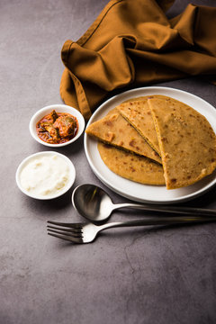 Sattu Ka Paratha / Stuffed Channa Dal Flour Paratha served with mango pickle and curd or dahi