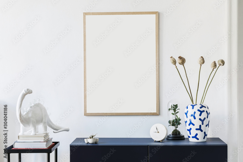 Wall mural stylish scandinavian living room with mock up poster frame, navy blue commode, table lamp and elegan