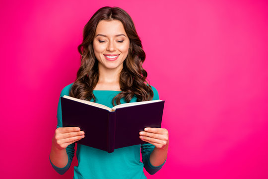 Photo of cheerful positive nice cute charming girlfriend looking thorugh her copybook in search of answers to questions she has smiling toothily isolated fuchsia color vivid background