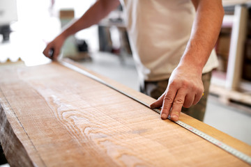 Carpenter using a measuring tape