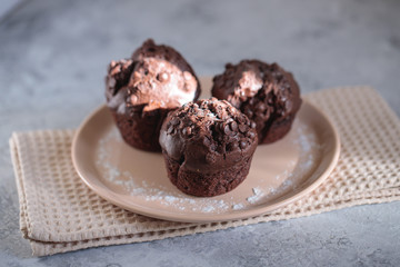 Chocolate muffins on a plate, close up. Space for text. Fresh bakery.