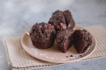 Chocolate muffins on a plate, close up. Space for text. Fresh bakery.