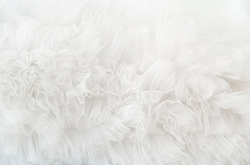 White ruffled wavy background. Soft tule cloth