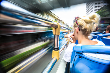 Open bus top view of tourist activity on double decker bus and motion blur