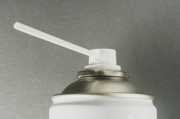 metal spray bottle, selective focus, silver background