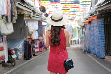 woman traveler tourist with map traveling on walking street. journey trip travel concept