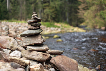 pile of stones on stony river bank in the forest