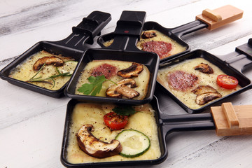 Delicious traditional Swiss melted raclette cheese on diced boiled or baked potato.