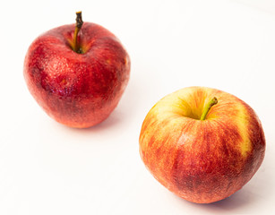 Red apple with drops isolated on white.