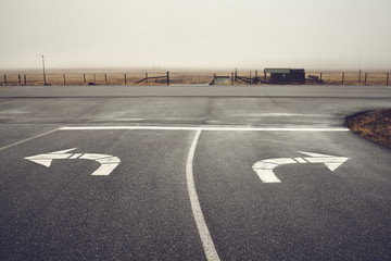 Left or right, roads intersection on a rainy day, color toning applied, Wyoming, USA. - obrazy, fototapety, plakaty