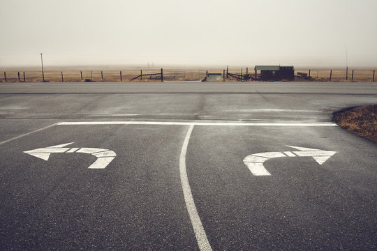 Left or right, roads intersection on a rainy day, color toning applied, Wyoming, USA.