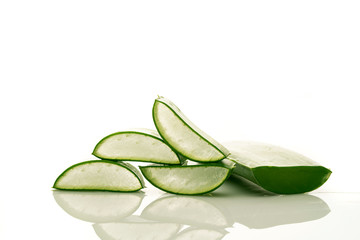 leaf and slices of aloe vera on white background