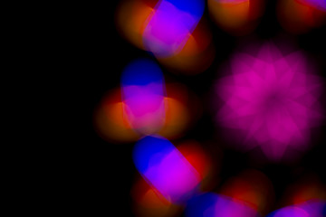 Defocused of photo bokeh blurred circle light from colorful neon lighting bulb in the night for abstract background texture pattern