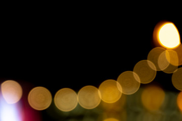 Defocused of photo bokeh blurred circle light from colorful neon lighting bulb in the night for abstract background texture pattern