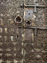 Ironwork weathered door of Trinite chapel in Belpuig hamlet, Prunet et Belpuig, Pyrenees Orientales, France.