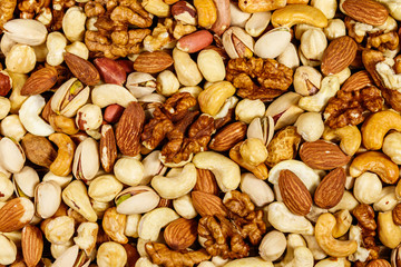 Background of mixed nuts (walnuts, pistachio, almond, peanut, cashew, hazelnut). Healthy eating concept