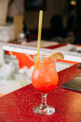 refreshing cocktail with ice and a bar on the bar