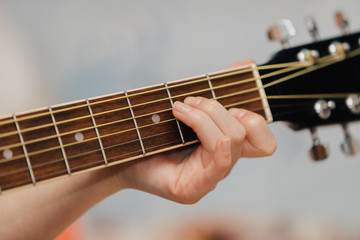 Hand holding a guitar
