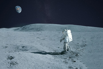 Astronaut is walking on the moon. With land on the horizon. Elements of this image were furnished by NASA.