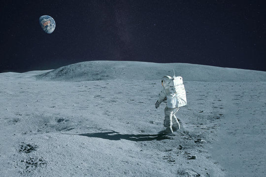 Astronaut is walking on the moon. With land on the horizon. Elements of this image were furnished by NASA. - Powered by Adobe