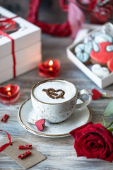 Cookies or gingerbread cookies in a gift box with a red ribbon on a wooden table. Valentine's Day.