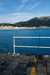 Obraz premium fishing rods on the waterfront in Giardini Naxos, Sicily, Italy