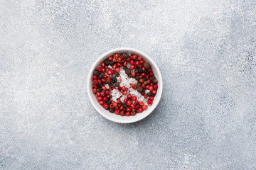 spices pepper salt in plates on a gray concrete table with copy space.
