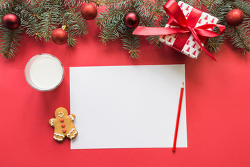 Christmas letter for Santa Claus with milk, cookies, gingerbread on red. Top view and space for your text. Flat lay.