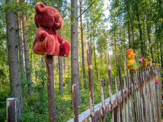 Teddy bear sitting on the fence