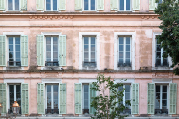 detail of typical French house, pink with green shutters in Antibes, Cote d'azure or French Riviera. South of France