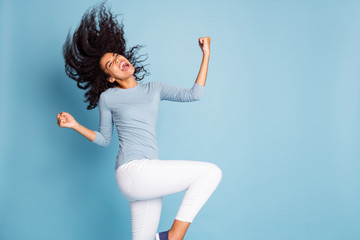 Photo of excited ecstatic overjoyed grimacing girlfriend throwing her hair by waving head in white pants blue sweater rejoicing isolated pastel color background - Powered by Adobe