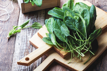 Fresh organic spinach on wooden board