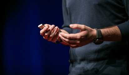 Speaker giving a talk on corporate Business Conference. Audience at the conference hall. Business and Entrepreneurship event.