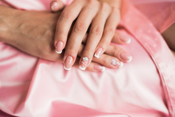 Luxury bride in white dress posing while preparing for the wedding ceremony