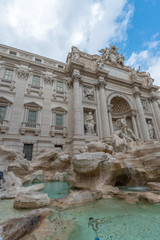 Naklejka premium Rome, Italy - October 07, 2018: The Trevi Fountain standing 26 meters high and 20 meters wide, it is the largest Baroque fountain in the city. Fountain di Trevi surronded by hundreds of tourists