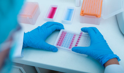 Woman collecting colored samples in box for testing them