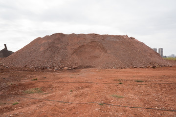 Close-up landscape view of towering stacked sand in large quarry