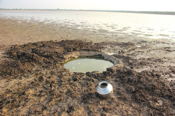 Obraz premium Water pool and steel drum for water storage on river side 