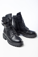 women's black demi-season leather boots on white background
