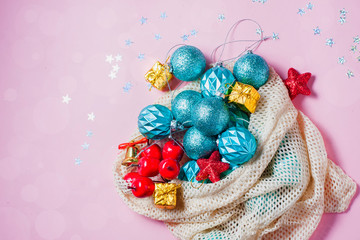 New Year or Christmas. New Year's toys in an environmentally friendly reusable bag on a pink background. Christmas 2020 celebrate, new year concept.