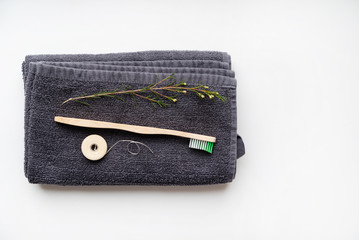 eco natural bamboo toothbrushes and biodegradable silk  dental floss on the black towel, ...